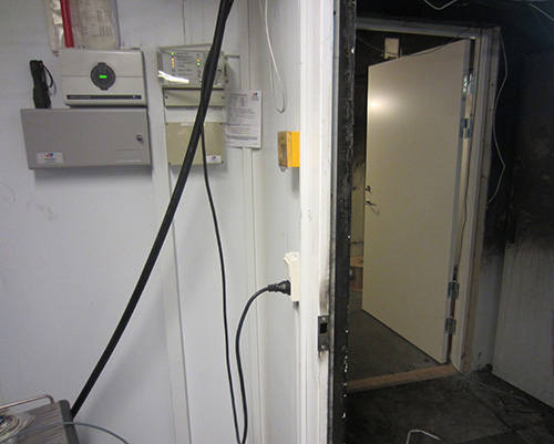 View out of ModuSec room to damaged outer room (with new emergency security door to outer area)